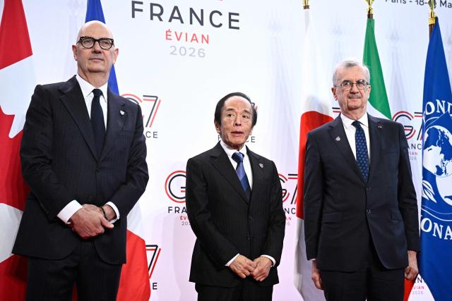 France's Economy, Finances and Industry Minister Roland Lescure (L) and Governor of the Bank of France François Villeroy de Galhau (R) greet Governor of the Bank of Japan Kazuo Ueda prior to a meeting of G7 Finance Ministers and Central Bank Governors in preparation for the summit of heads of State and government to be held in June 2026 in Evian, in Paris on May 18, 2026. (Photo by JULIEN DE ROSA / AFP)