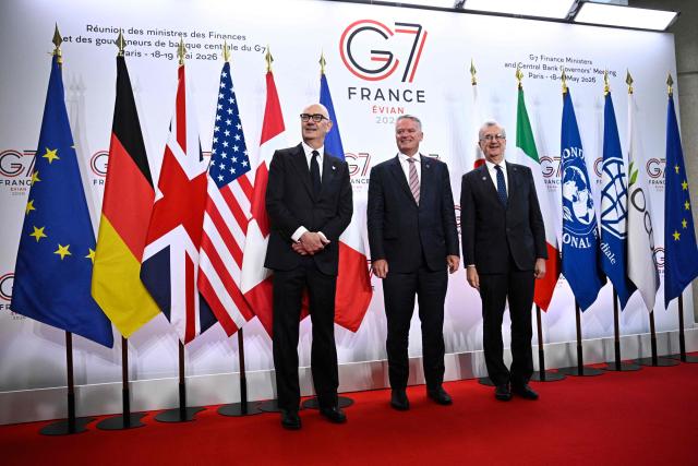 France's Economy, Finances and Industry Minister Roland Lescure (L) and Governor of the Bank of France François Villeroy de Galhau (R) greet Secretary-General of the Organisation for Economic Co-operation and Development (OECD) Mathias Cormann prior to a meeting of G7 Finance Ministers and Central Bank Governors in preparation for the summit of heads of State and government to be held in June 2026 in Evian, in Paris on May 18, 2026. (Photo by JULIEN DE ROSA / AFP)