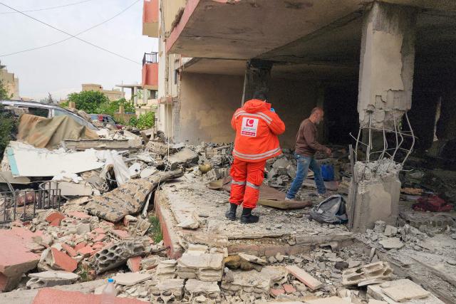 An emergency worker inspects the damage following an Israeli strike on an apartment building in Baalbek on May 18, 2026. An Israeli missile strike on an apartment in eastern Lebanon on May 17 killed an Islamic Jihad commander and his 17-year-old daughter, Lebanese state media said. (Photo by AFP)