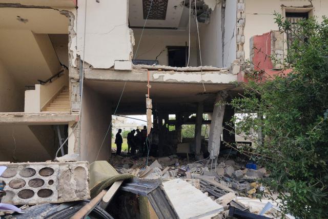 Emergency workers inspect the damage following an Israeli strike on an apartment building in Baalbek on May 18, 2026. An Israeli missile strike on an apartment in eastern Lebanon on May 17 killed an Islamic Jihad commander and his 17-year-old daughter, Lebanese state media said. (Photo by AFP)