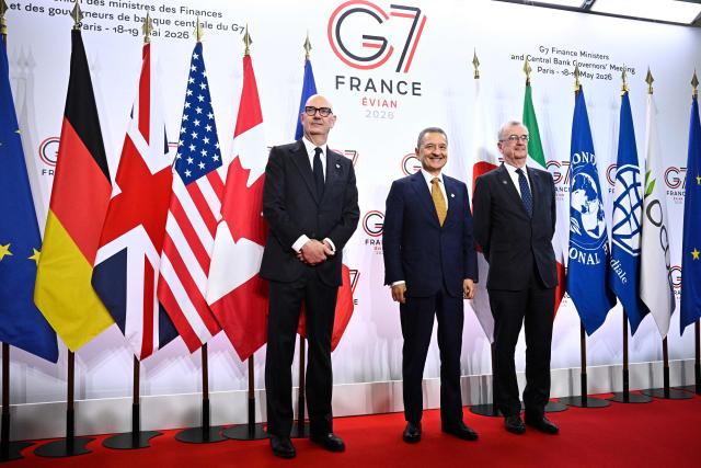France's Economy, Finances and Industry Minister Roland Lescure (L) and Governor of the Bank of France François Villeroy de Galhau (R) greet Governor of the Bank of Italy Fabio Panetta prior to a meeting of G7 Finance Ministers and Central Bank Governors in preparation for the summit of heads of State and government to be held in June 2026 in Evian, in Paris on May 18, 2026. (Photo by JULIEN DE ROSA / AFP)