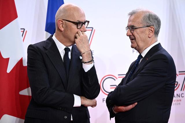 France's Economy, Finances and Industry Minister Roland Lescure (L) speaks with Governor of the Bank of France François Villeroy de Galhau as they wait for their guests prior to a meeting of G7 Finance Ministers and Central Bank Governors in preparation for the summit of heads of State and government to be held in June 2026 in Evian, in Paris on May 18, 2026. (Photo by JULIEN DE ROSA / AFP)