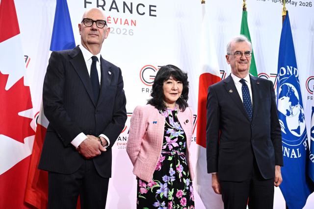 France's Economy, Finances and Industry Minister Roland Lescure (L) and Governor of the Bank of France François Villeroy de Galhau (R) greet Japan's Minister of Finance Satsuki Katayama prior to a meeting of G7 Finance Ministers and Central Bank Governors in preparation for the summit of heads of State and government to be held in June 2026 in Evian, in Paris on May 18, 2026. (Photo by JULIEN DE ROSA / AFP)