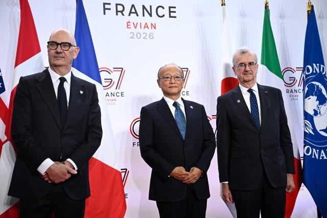 France's Economy, Finances and Industry Minister Roland Lescure (L) and Governor of the Bank of France François Villeroy de Galhau (R) greet President of the Asian Development Bank (ADB) Masato Kanda prior to a meeting of G7 Finance Ministers and Central Bank Governors in preparation for the summit of heads of State and government to be held in June 2026 in Evian, in Paris on May 18, 2026. (Photo by JULIEN DE ROSA / AFP)