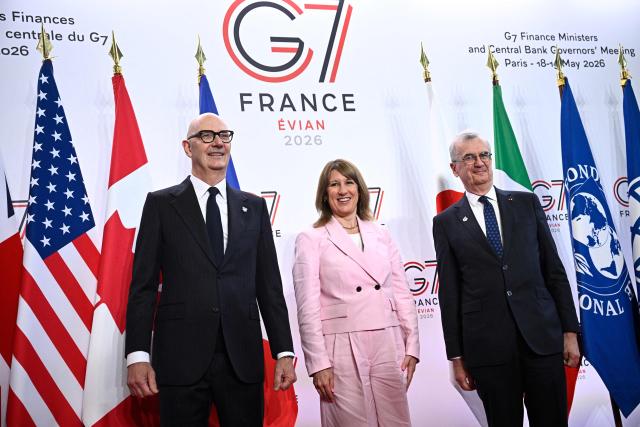 France's Economy, Finances and Industry Minister Roland Lescure (L) and Governor of the Bank of France François Villeroy de Galhau (R) greet Britain's Chancellor of the Exchequer Rachel Reeves prior to a meeting of G7 Finance Ministers and Central Bank Governors in preparation for the summit of heads of State and government to be held in June 2026 in Evian, in Paris on May 18, 2026. (Photo by JULIEN DE ROSA / AFP)