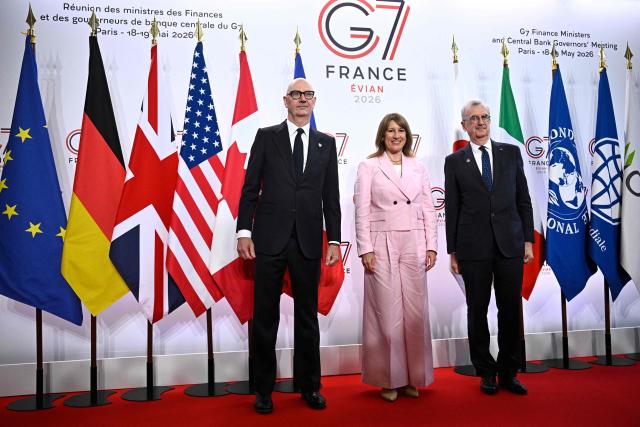 France's Economy, Finances and Industry Minister Roland Lescure (L) and Governor of the Bank of France François Villeroy de Galhau (R) greet Britain's Chancellor of the Exchequer Rachel Reeves prior to a meeting of G7 Finance Ministers and Central Bank Governors in preparation for the summit of heads of State and government to be held in June 2026 in Evian, in Paris on May 18, 2026. (Photo by JULIEN DE ROSA / AFP)