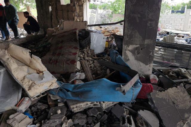 People check the damages following an Israeli strike on an apartment building in Baalbek on May 18, 2026. An Israeli missile strike on an apartment in eastern Lebanon on May 17 killed an Islamic Jihad commander and his 17-year-old daughter, Lebanese state media said. (Photo by AFP)