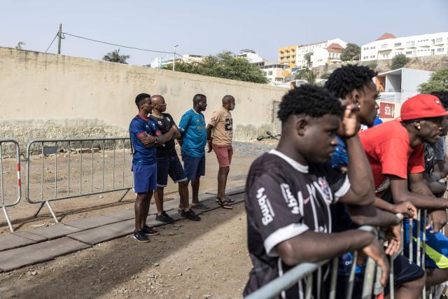 Supporters watch during the Praia Cup final football match between Desportivo da Praia and Sporting Clube da Praia at the Estadio da Varzea in Praia, on April 4, 2026. Both teams played the final for a chance to qualify for the Cape Verdean Cup, a knockout tournament that brings together the champions of each island. 
This archipelago of 10 islands is the smallest African nation ever to qualify for a World Cup with a population of just 550,000. 
The national team, known as the Blue Sharks, will compete in Group H against Spain, Saudi Arabia, and Uruguay. 
Their World Cup qualification has inspired many players in the local leagues, who now dream of joining the national team and representing their country. (Photo by PATRICK MEINHARDT / AFP)