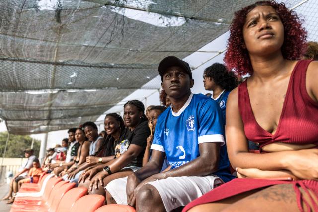 A Desportivo da Praia supporter watches during the Praia Cup final football match between Desportivo da Praia and Sporting Clube da Praia at the Estadio da Varzea in Praia, on April 4, 2026. Both teams played the final for a chance to qualify for the Cape Verdean Cup, a knockout tournament that brings together the champions of each island. 
This archipelago of 10 islands is the smallest African nation ever to qualify for a World Cup with a population of just 550,000. 
The national team, known as the Blue Sharks, will compete in Group H against Spain, Saudi Arabia, and Uruguay. 
Their World Cup qualification has inspired many players in the local leagues, who now dream of joining the national team and representing their country. (Photo by PATRICK MEINHARDT / AFP)