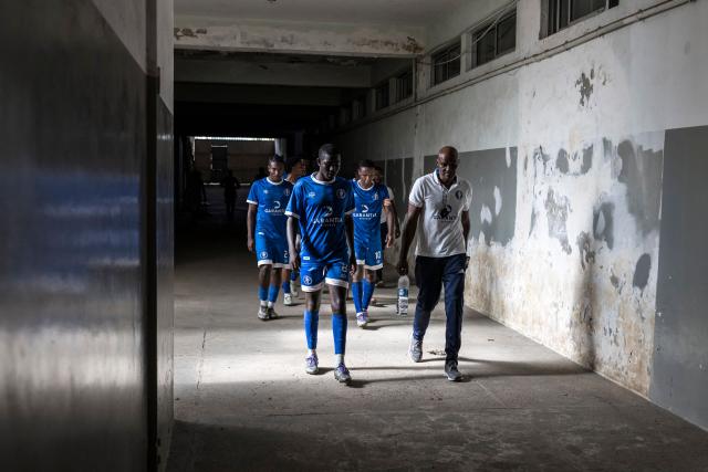 Desportivo da Praia players walk back into the football pitch during half-time of the Praia Cup final football match between Desportivo da Praia and Sporting Clube da Praia at the Estadio da Varzea in Praia, on April 4, 2026. Both teams played the final for a chance to qualify for the Cape Verdean Cup, a knockout tournament that brings together the champions of each island. 
This archipelago of 10 islands is the smallest African nation ever to qualify for a World Cup with a population of just 550,000. 
The national team, known as the Blue Sharks, will compete in Group H against Spain, Saudi Arabia, and Uruguay. 
Their World Cup qualification has inspired many players in the local leagues, who now dream of joining the national team and representing their country. (Photo by PATRICK MEINHARDT / AFP)