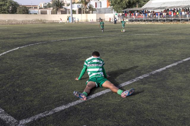 A Sporting Clube da Praia player covers his face with his jersey after losing the Praia Cup final football match between Desportivo da Praia and Sporting Clube da Praia at the Estadio da Varzea in Praia, on April 4, 2026. Both teams played the final for a chance to qualify for the Cape Verdean Cup, a knockout tournament that brings together the champions of each island. 
This archipelago of 10 islands is the smallest African nation ever to qualify for a World Cup with a population of just 550,000. 
The national team, known as the Blue Sharks, will compete in Group H against Spain, Saudi Arabia, and Uruguay. 
Their World Cup qualification has inspired many players in the local leagues, who now dream of joining the national team and representing their country. (Photo by PATRICK MEINHARDT / AFP)