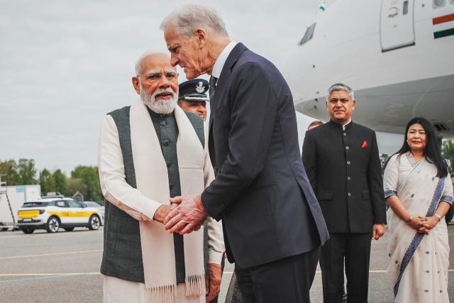 India's Prime Minister Narendra Modi (L) is welcomed by Norway's Prime Minister Jonas Gahr Store (2nd L) at his arrival at the Gardermoen airport in Olso, Norway, on May 18, 2026, to attend the third Nordic-Indian Summit. India's Prime Minister Narendra Modi is on five-nation tour and will attend the third Nordic-Indian Summit on May 18 and 19, 2026. (Photo by Stian Lysberg Solum / NTB / AFP) / Norway OUT