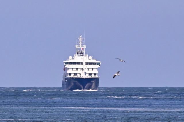 The Dutch Hantavirus-hit cruise ship MV Hondius sails off the Netherlands' coast as it approaches the port of Rotterdam on May 18, 2026. Cruise ship MV Hondius is expected to arrive at the port of Rotterdam and the ship's crew members will undergo a medical screening. (Photo by JOHN THYS / AFP)