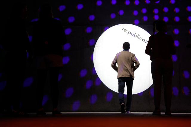 A man walks towards a spotlight at the Re:Publica fair ground on the opening day of  the Re:publica digital conference in Berlin, Germany, on May 18, 2026. (Photo by Odd ANDERSEN / AFP)