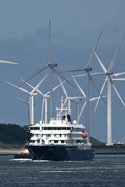 The Dutch Hantavirus-hit cruise ship MV Hondius sails off the Netherlands' coast as it approaches the port of Rotterdam on May 18, 2026. Cruise ship MV Hondius is expected to arrive at the port of Rotterdam and the ship's crew members will undergo a medical screening. (Photo by NICOLAS TUCAT / AFP)
