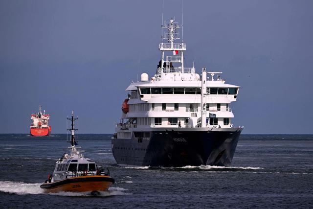 The Dutch Hantavirus-hit cruise ship MV Hondius sails off the Netherlands' coast as it approaches the port of Rotterdam on May 18, 2026. Cruise ship MV Hondius is expected to arrive at the port of Rotterdam and the ship's crew members will undergo a medical screening. (Photo by JOHN THYS / AFP)
