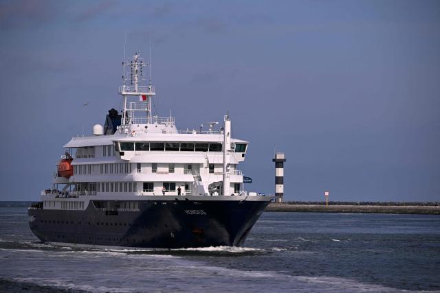 The Dutch Hantavirus-hit cruise ship MV Hondius sails off the Netherlands' coast as it approaches the port of Rotterdam on May 18, 2026. Cruise ship MV Hondius is expected to arrive at the port of Rotterdam and the ship's crew members will undergo a medical screening. (Photo by JOHN THYS / AFP)