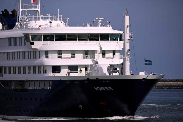 The Dutch Hantavirus-hit cruise ship MV Hondius sails off the Netherlands' coast as it approaches the port of Rotterdam on May 18, 2026. Cruise ship MV Hondius is expected to arrive at the port of Rotterdam and the ship's crew members will undergo a medical screening. (Photo by JOHN THYS / AFP)