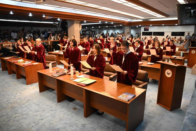 Philippine senators take their oath as jurors in the impeachment trial of Vice President Sara Duterte at the plenary hall of the Senate in Manila on May 18, 2026. (Photo by Ted ALJIBE / AFP)