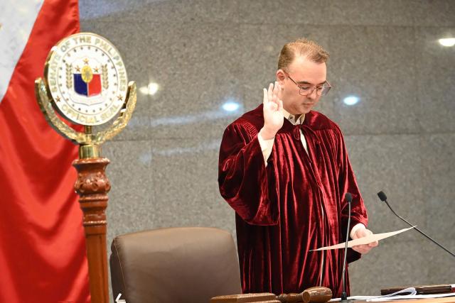 Philippine Senate President Alan Cayetano leads senators as they take their oath as jurors in the impeachment trial of Vice President Sara Duterte at the plenary hall of the Senate in Manila on May 18, 2026. (Photo by Ted ALJIBE / AFP)