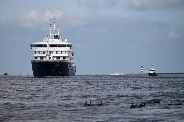 The Dutch Hantavirus-hit cruise ship MV Hondius sails off the Netherlands' coast as it approaches the port of Rotterdam on May 18, 2026. Cruise ship MV Hondius is expected to arrive at the port of Rotterdam and the ship's crew members will undergo a medical screening. (Photo by Nicolas TUCAT / AFP)