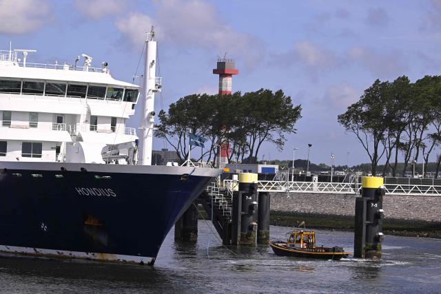 The Dutch Hantavirus-hit cruise ship MV Hondius arrives to dock at the port of Rotterdam on May 18, 2026. Cruise ship MV Hondius arrived at the port of Rotterdam and the ship's crew members will undergo a medical screening. (Photo by JOHN THYS / AFP)