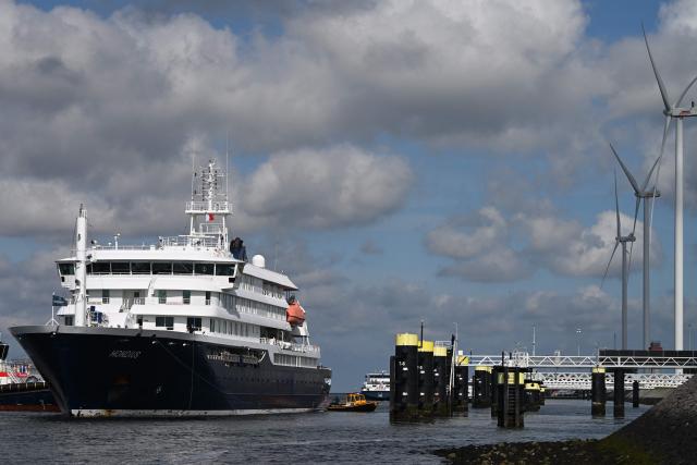 The Dutch Hantavirus-hit cruise ship MV Hondius arrives to dock at the port of Rotterdam on May 18, 2026. Cruise ship MV Hondius arrived at the port of Rotterdam and the ship's crew members will undergo a medical screening. (Photo by Nicolas TUCAT / AFP)
