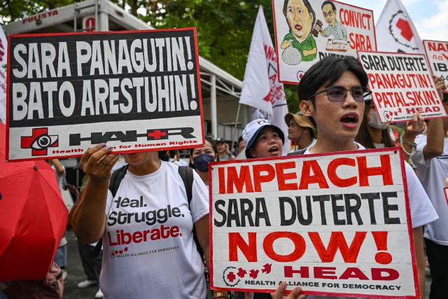 Protesters hold placards reading "Hold Sara accountable, arrest Bato" and "Impeach Sara Duterte now" during a demonstration to call for the start of the impeachment trial against Philippine Vice-President Sara Duterte and the arrest of Philippine Senator Ronald "Bato" Dela Rosa outside the Senate of the Philippines in Pasay, Metro Manila on May 18, 2026. (Photo by Jam STA ROSA / AFP)