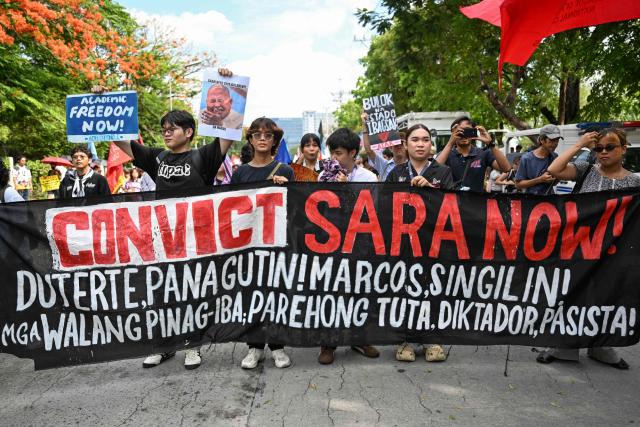 Protesters hold a banner during a demonstration to call for the start of the impeachment trial against Philippine Vice-President Sara Duterte and the arrest of Philippine Senator Ronald "Bato" Dela Rosa outside the Senate of the Philippines in Pasay, Metro Manila on May 18, 2026. (Photo by Jam STA ROSA / AFP)