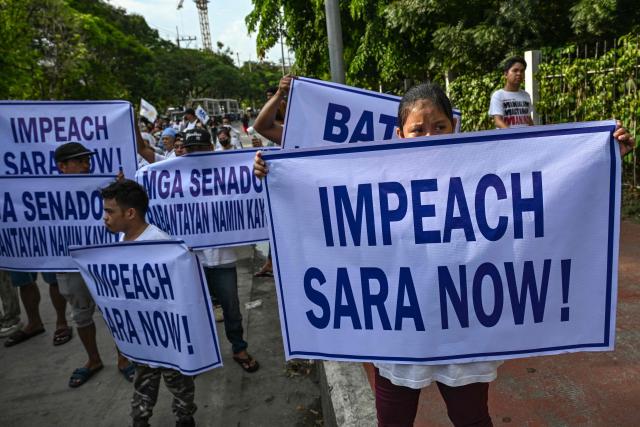 Protesters hold signs during a demonstration to call for the start of the impeachment trial against Philippine Vice-President Sara Duterte and the arrest of Philippine Senator Ronald "Bato" Dela Rosa outside the Senate of the Philippines in Pasay, Metro Manila on May 18, 2026. (Photo by Jam STA ROSA / AFP)
