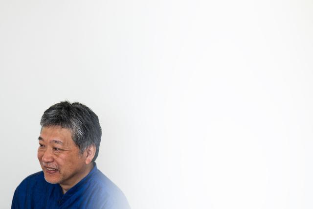Japanese director and screenwriter Hirokazu Kore-eda smiles during an interview on the sidelines of the 79th edition of the Cannes Film Festival in Cannes, southern France, on May 17, 2026. Hirokazu Kore-eda, a leading figure in Japanese cinema and winner of the 2018 Palme d’Or, said on May 17, 2026 in Cannes – where his new film "Sheep in the Box" is in competition – that he would fight “to the very end” to ensure that a human being is involved “at every stage of film production”. (Photo by Julie SEBADELHA / AFP)