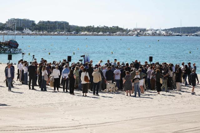 People attend a ceremony to rename Plage Mace "Brigitte Bardot Beach" on the sidelines of the 79th edition of the Cannes Film Festival in Cannes, southern France, on May 18, 2026. (Photo by Sameer AL-DOUMY / AFP)