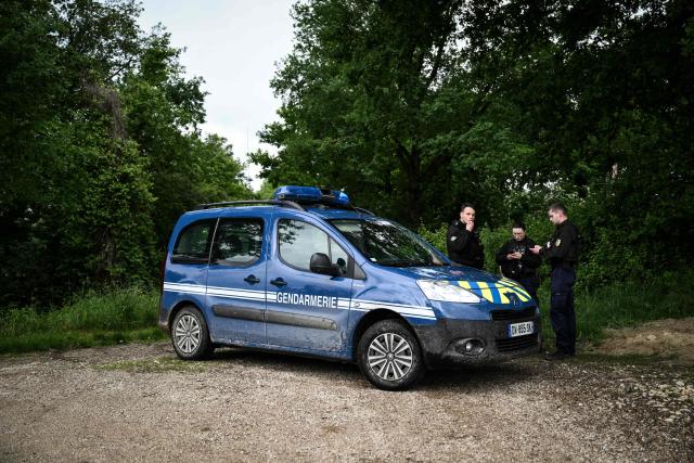 French police officers stand guard on a path as new excavations start for victims of alleged serial killer Emile Louis, in Rouvray, central-eastern France on May 18, 2026. These new excavations are the third in less than two years, following digs carried out in the autumn of 2024 and then in May 2025. (Photo by ARNAUD FINISTRE / AFP)