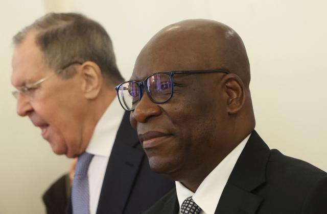 Russian Foreign Minister Sergei Lavrov and Minister of Foreign Affairs and International Cooperation of Equatorial Guinea Simeon Oyono Esono Angue enter a hall during their meeting in Moscow on May 18, 2026. (Photo by MAXIM SHIPENKOV / POOL / AFP)