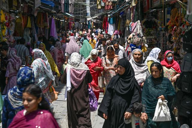 People throng a market in Srinagar on May 18, 2026. (Photo by Tauseef MUSTAFA / AFP)