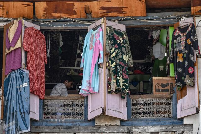 A trailor works at a shop in Srinagar on May 18, 2026. (Photo by Tauseef MUSTAFA / AFP)