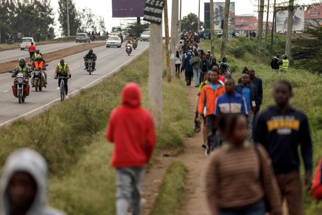Kenyans walk to work during a nationwide transport strike over rising fuel prices in Nairobi on May 18, 2026. Public transport was largely shut down and protesters barricaded roads in Kenya on May 18, 2026 as a strike was called over a fuel price hike triggered by the Middle East war.
Kenya is one of many African countries dependent on fuel imports from the Gulf, and heavily hit by Iran's effective closure of the Strait of Hormuz through which a fifth of the world's oil normally passes. (Photo by SIMON MAINA / AFP)