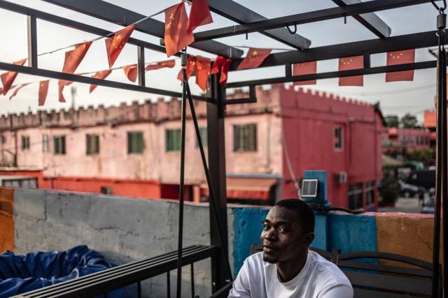 A mechanic looks on as he takes a break inside China Town in the Ojota neighbourhood of Lagos on May 4, 2026. (Photo by OLYMPIA DE MAISMONT / AFP)
