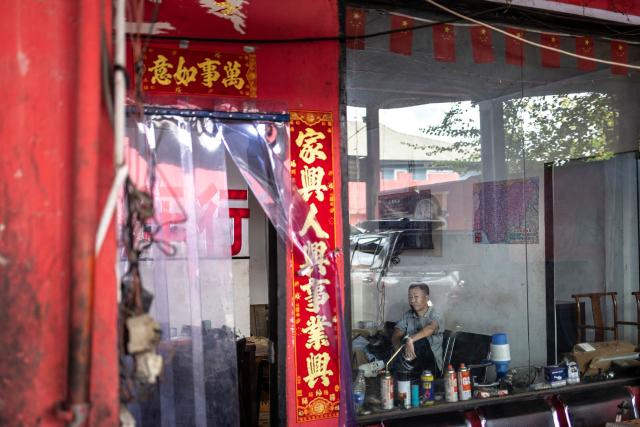 TOPSHOT - A customer waits for his car inside a garage shop at China Town in the Ojota neighbourhood of Lagos on May 5, 2026. (Photo by OLYMPIA DE MAISMONT / AFP)