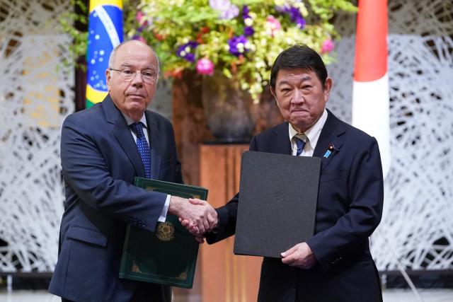 Brazil's Foreign Minister Mauro Vieira (L) shakes hands with his Japanese counterpart Toshimitsu Motegi at a signing ceremony after their meeting of the 1st Japan-Brazil Foreign Ministers' Strategic Dialogue in Tokyo on May 18, 2026. (Photo by Kazuhiro NOGI / AFP)