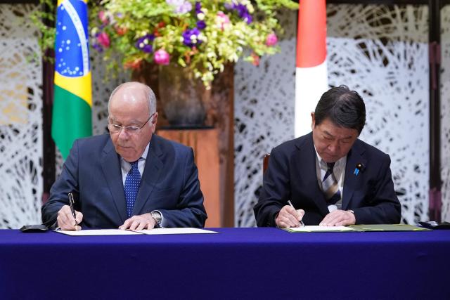 Brazil's Foreign Minister Mauro Vieira (L) and his Japanese counterpart Toshimitsu Motegi attend a signing ceremony after their meeting of the 1st Japan-Brazil Foreign Ministers' Strategic Dialogue in Tokyo on May 18, 2026. (Photo by Kazuhiro NOGI / AFP)