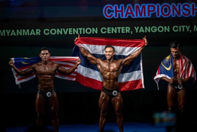 Bodybuilders celebrate after competing in the 20th South East Asian Championships 2026 at the Myanmar Convention Centre in Yangon on May 17, 2026. (Photo by Sai Aung MAIN / AFP)