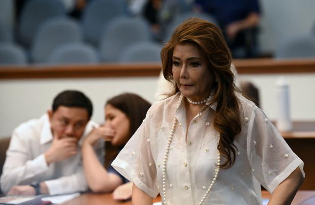 Philippine senator Imee Marcos, elder sister of President Ferdinand Marcos Jr. arrives for regular session prior to taking their oath as jurors in the impeachment trial of Vice President Sara Duterte at the plenary hall of the Senate in Manila on May 18, 2026. Philippine lawmakers were sworn in on May 18 to serve as judges in the trial of impeached Vice President Sara Duterte, the second attempt since last year to force her from office. (Photo by Ted ALJIBE / AFP)