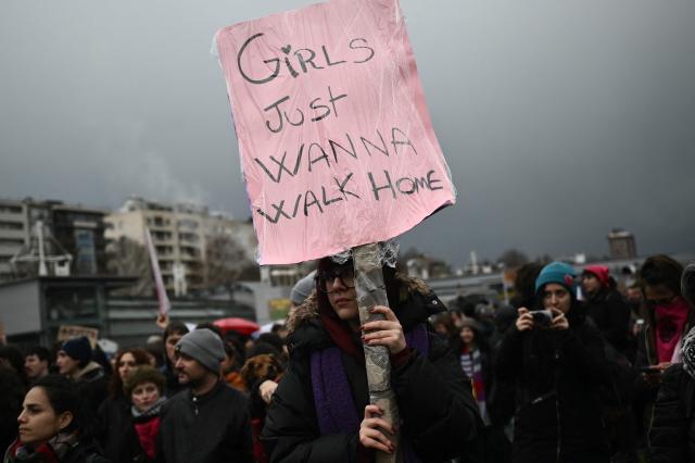 (FILES) A demonstrator holds a placard reading "Girls just wanna walk home" as she takes part in the Women March against Violence, as part of International Women's day, in Turin, on March 8, 2024. Rapists could be given a legal assist in Italy by a controversial change to a bill redefining sexual violence, after the far right torpedoed an "only yes means yes" definition, experts say. Consent-based rape laws already exist in several European countries including France, Germany and Spain, but an attempt to follow suit in Italy risks backfiring. (Photo by MARCO BERTORELLO / AFP)