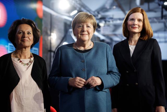 (From L) Former State Premier of the western federal state of Rhineland-Palatinate Malu Dreyer, Former German Chancellor and member of the conservative Christian Democratic Union (CDU) Angela Merkel and Director of public broadcaster WDR Katrin Vernau pose for medias at the Re:Publica fair ground during the opening of the Re:publica digital conference in Berlin, Germany, on May 18, 2026. (Photo by Odd ANDERSEN / AFP)