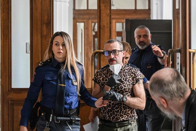 Marla-Svenja Liebich (C), a convicted German far-right extremist and neo-Nazi formerly known as Sven is escorted by Czech prison service to the Regional court on May 18, 2026 in Pilsen, Czech Republic, where Leibich will wait for court decision to decide on extradition to Germany. (Photo by Michal Cizek / AFP)