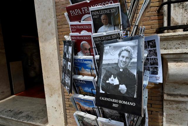 Calendars displaying pictures of models dressed as priests are on sale in souvenirs shops, in Rome on May 18, 2026. (Photo by Andreas SOLARO / AFP)