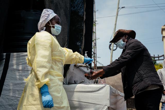 TOPSHOT - A visitor washes his hands before entering Kyeshero Hospital at a checkpoint for hand washing and temperature screening for all visitors and patients entering Kyeshero Hospital, as part of Ebola prevention measures in Goma on May 18, 2026. A first case of Ebola virus infection has been reported in Goma, a major city in eastern Democratic Republic of Congo controlled by the M23 armed group, with the WHO declaring an international health alert on May 17, 2026. (Photo by Jospin Mwisha / AFP)