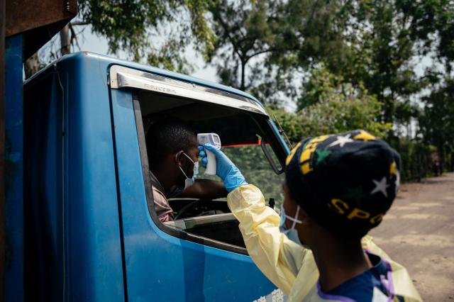 A visitor has their temperature checked by a health worker using a thermoflash before entering Kyeshero Hospital at a checkpoint for temperature screening for all visitors and patients entering Kyeshero Hospital, as part of Ebola prevention measures in Goma on May 18, 2026. A first case of Ebola virus infection has been reported in Goma, a major city in eastern Democratic Republic of Congo controlled by the M23 armed group, with the WHO declaring an international health alert on May 17, 2026. (Photo by Jospin Mwisha / AFP)