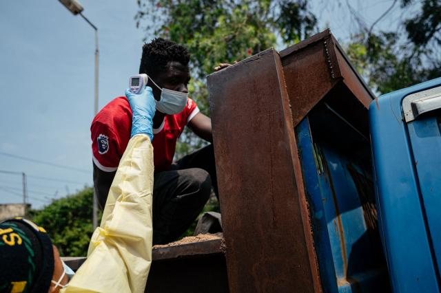 A visitor has their temperature checked by a health worker using a thermoflash before entering Kyeshero Hospital at a checkpoint for temperature screening for all visitors and patients entering Kyeshero Hospital, as part of Ebola prevention measures in Goma on May 18, 2026. A first case of Ebola virus infection has been reported in Goma, a major city in eastern Democratic Republic of Congo controlled by the M23 armed group, with the WHO declaring an international health alert on May 17, 2026. (Photo by Jospin Mwisha / AFP)